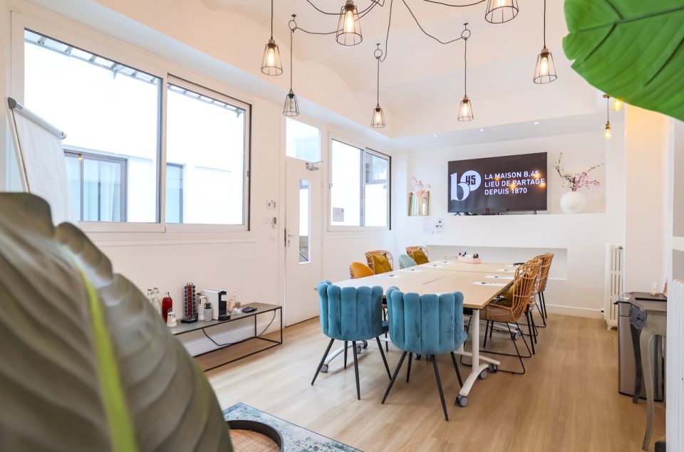 Salle Lainé-Lafarie vue d'angle avec table en rectangle et chaise devant la télévision